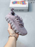 Gray Nike Mind 002 kids sneaker with perforated upper, lace-up closure and segmented sole.