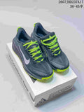 Pair of dark gray and neon lime Nike ACG trail shoes displayed on a shoe box.