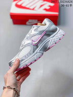 Side profile of a white, silver, and pink Nike sneaker showing layered panels, mesh-style sections, and the outsole design; overlay shows style code 2607JJD234A24 and sizes 36–41.5.
