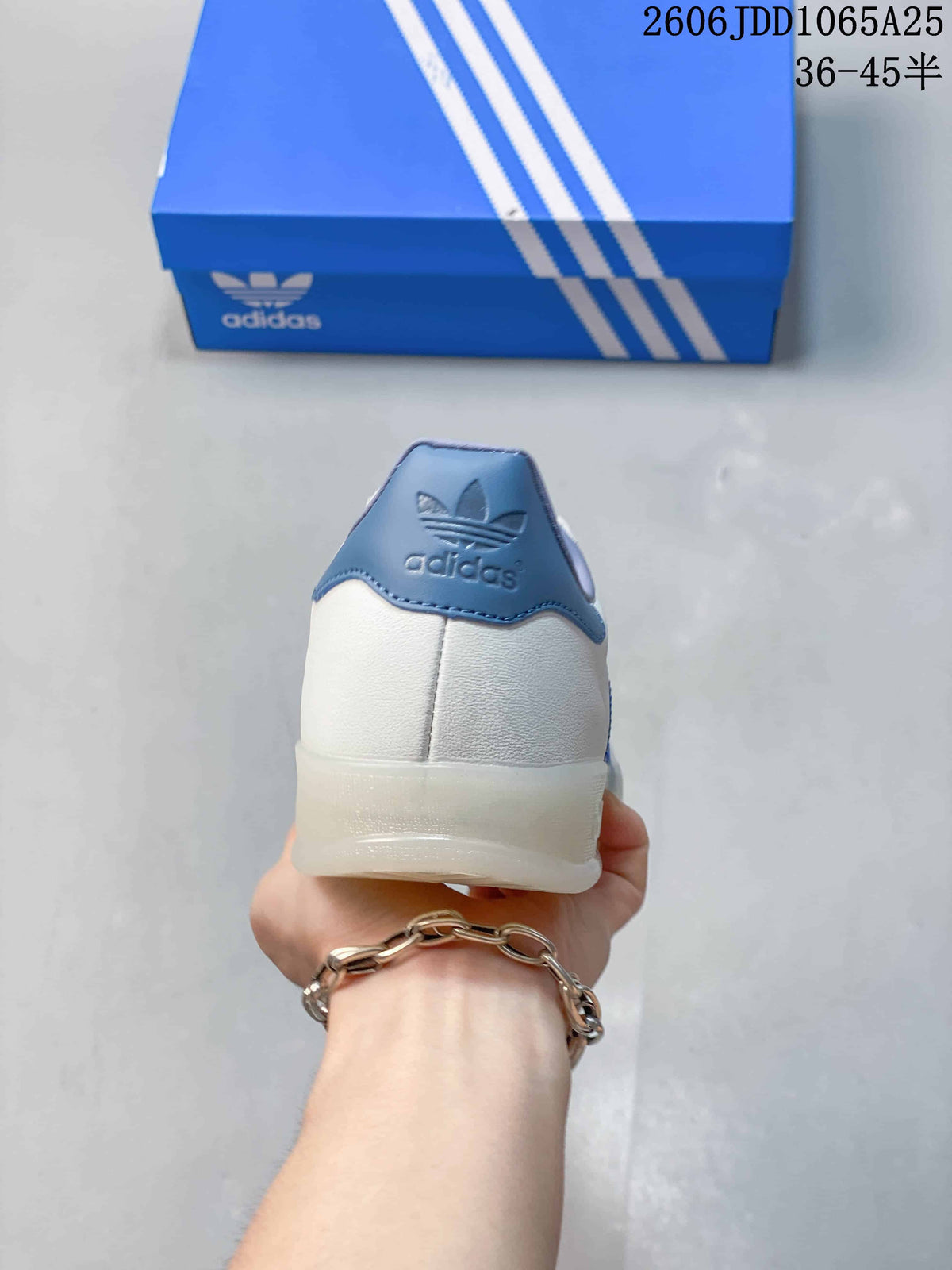 Rear view showing the white heel, blue padded collar, adidas logo, and translucent outsole.