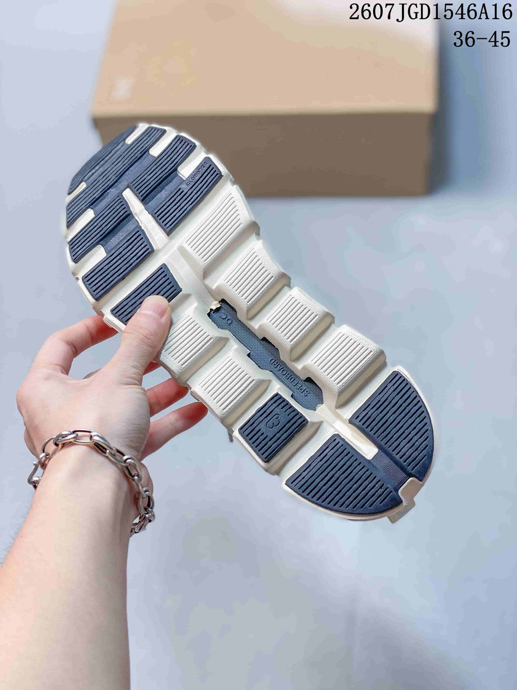 Close-up of the segmented sneaker outsole showing white and dark traction sections.