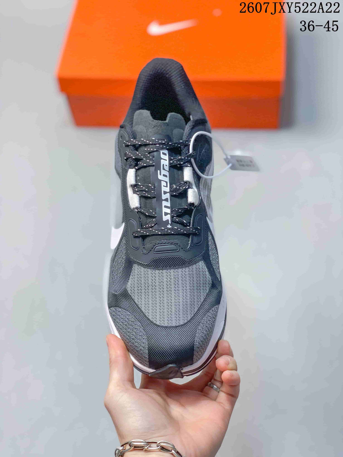 Top view of a black and gray Nike running shoe with patterned laces and a mesh-style toe box