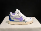 Opposite side profile of the white sneaker showing layered panels, lavender detailing, blue heel accent and cream outsole.