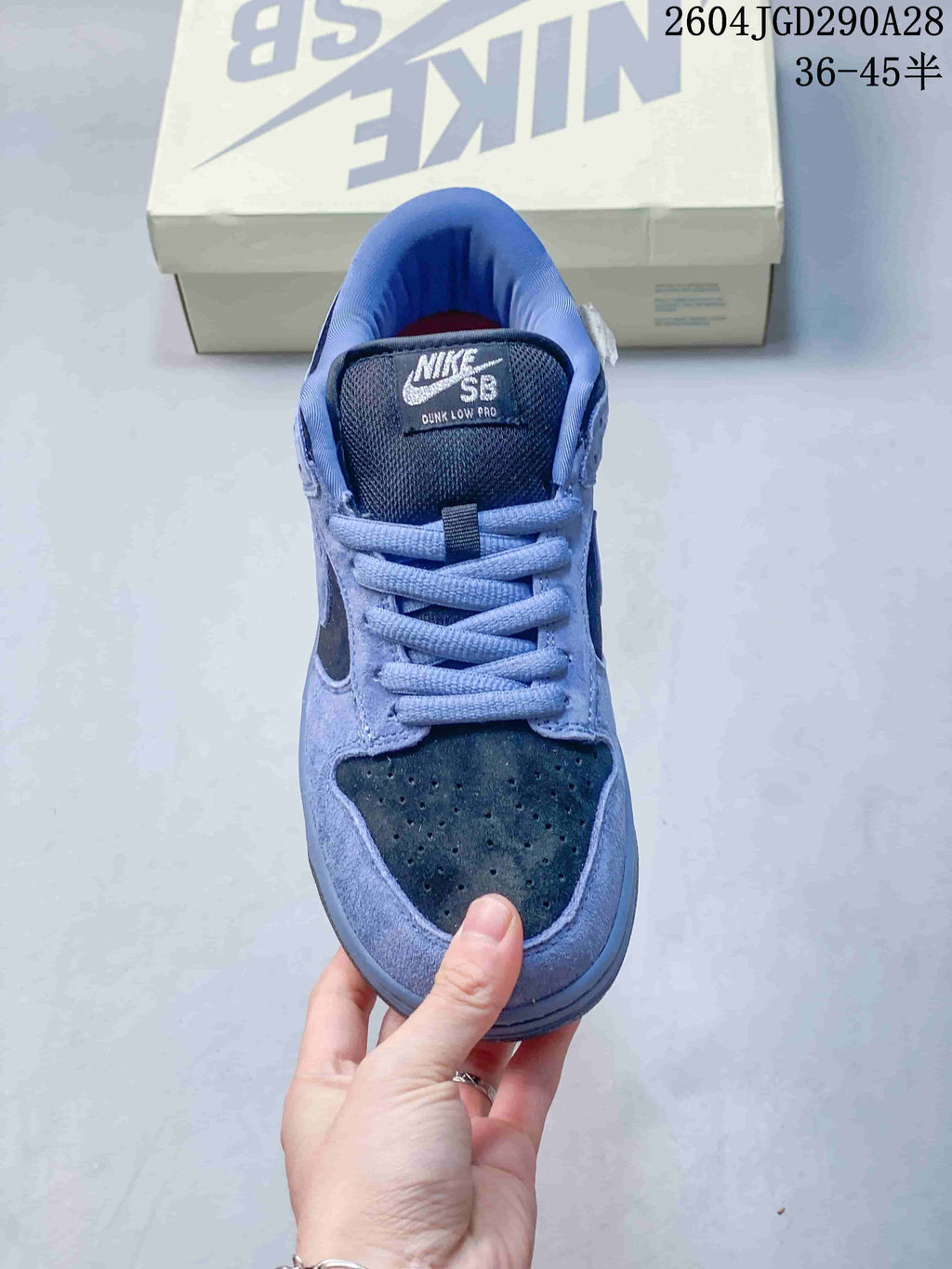 Front view of a blue Nike SB Dunk Low Pro sneaker with dark perforated toe panel