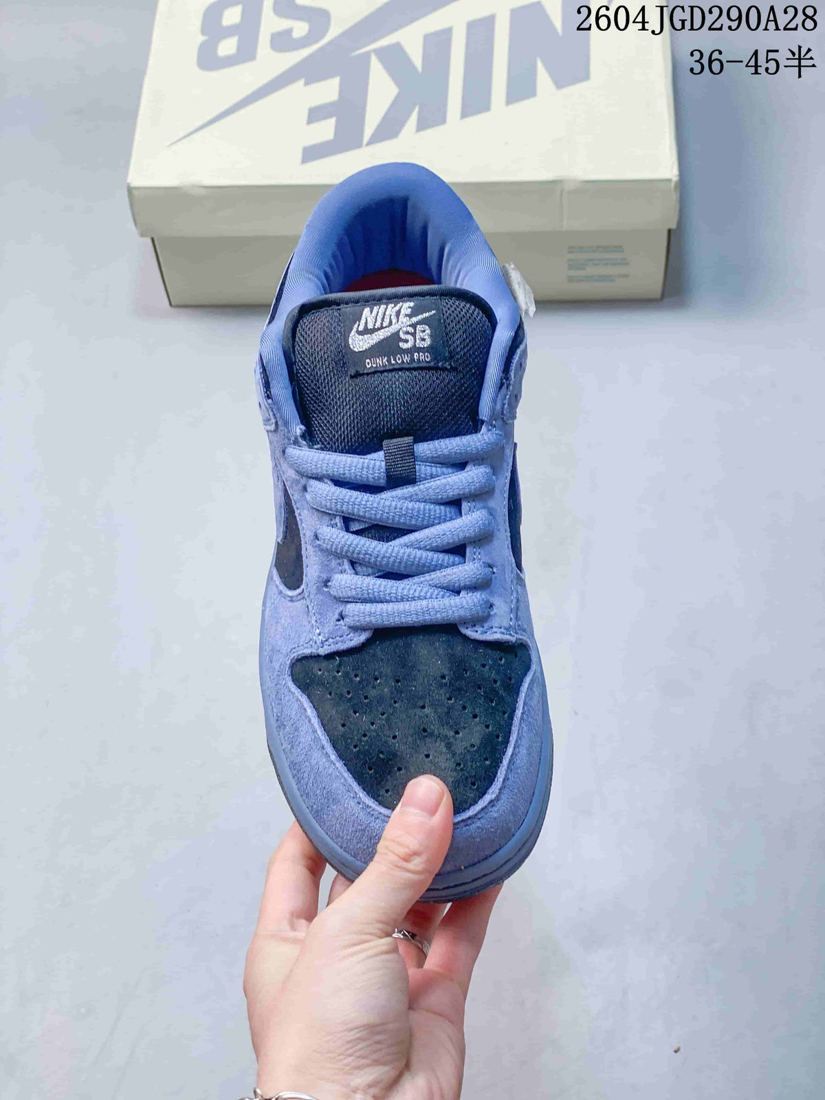 Front view of a blue Nike SB Dunk Low Pro sneaker with dark perforated toe panel