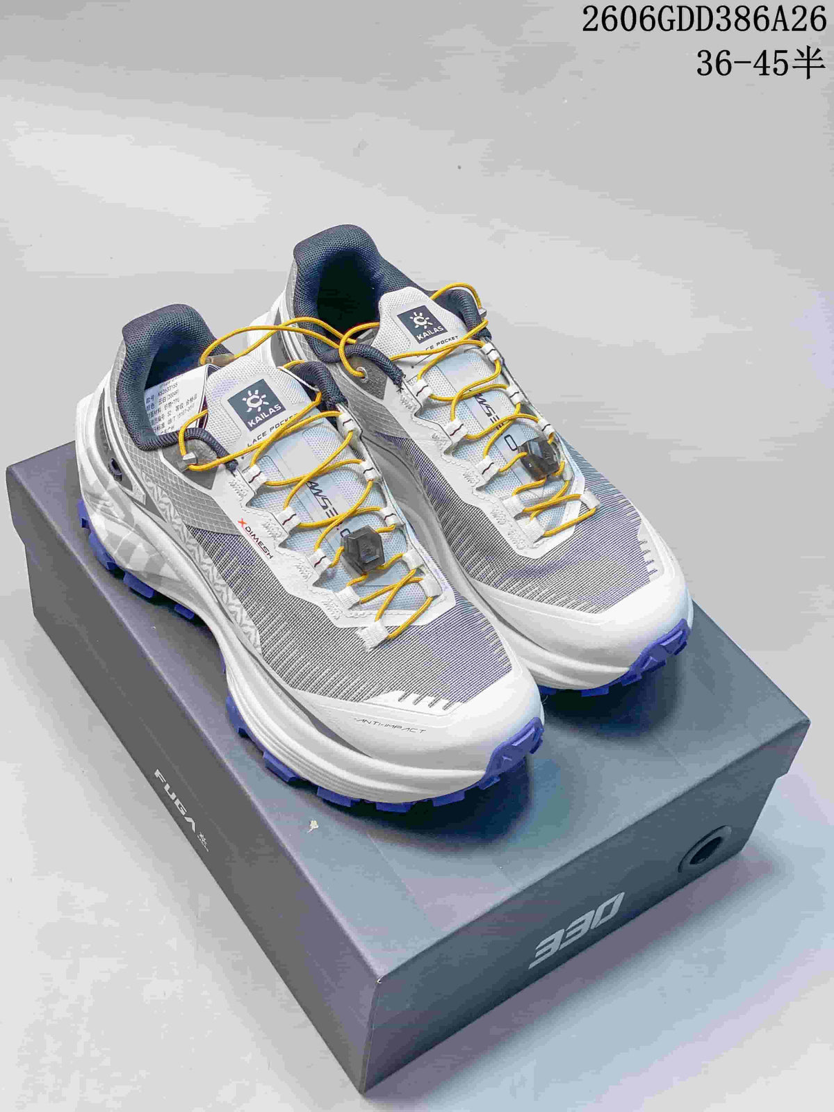 Pair of white and gray Kailas FUGA EX330 trail running shoes with yellow laces and purple lugged outsoles