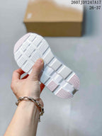 Underside view showing the white outsole with textured tread and geometric cutouts.