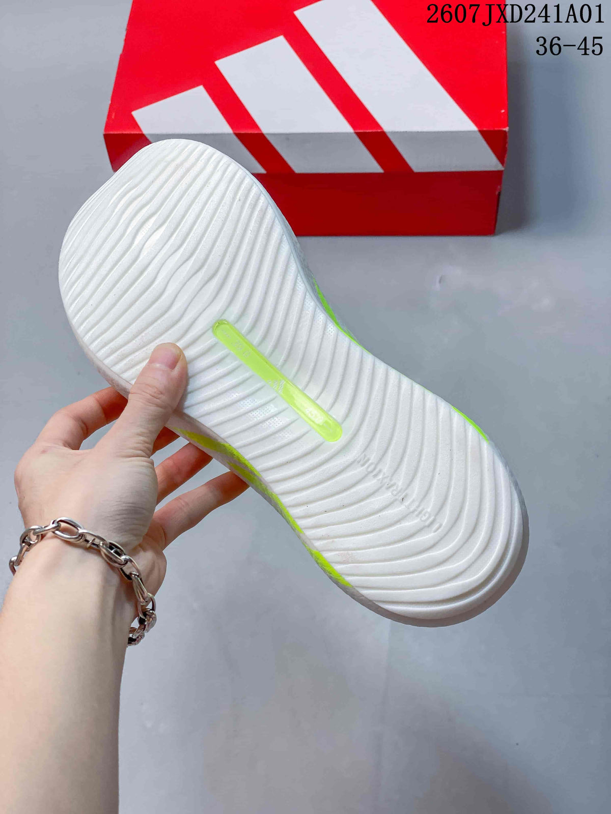 Underside view of the white running shoe showing a ridged outsole and neon-yellow accent.