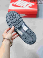 Close-up of the black and gray outsole showing its molded tread pattern and textured central section.