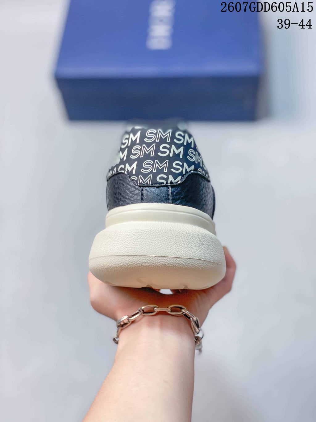 Rear view of the sneaker showing the cream outsole and patterned heel detail.