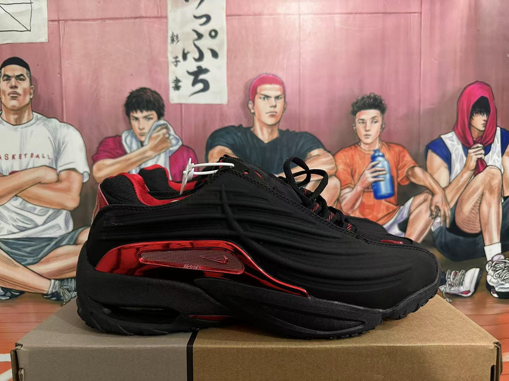 Side profile of a black and red Nike Shox sneaker