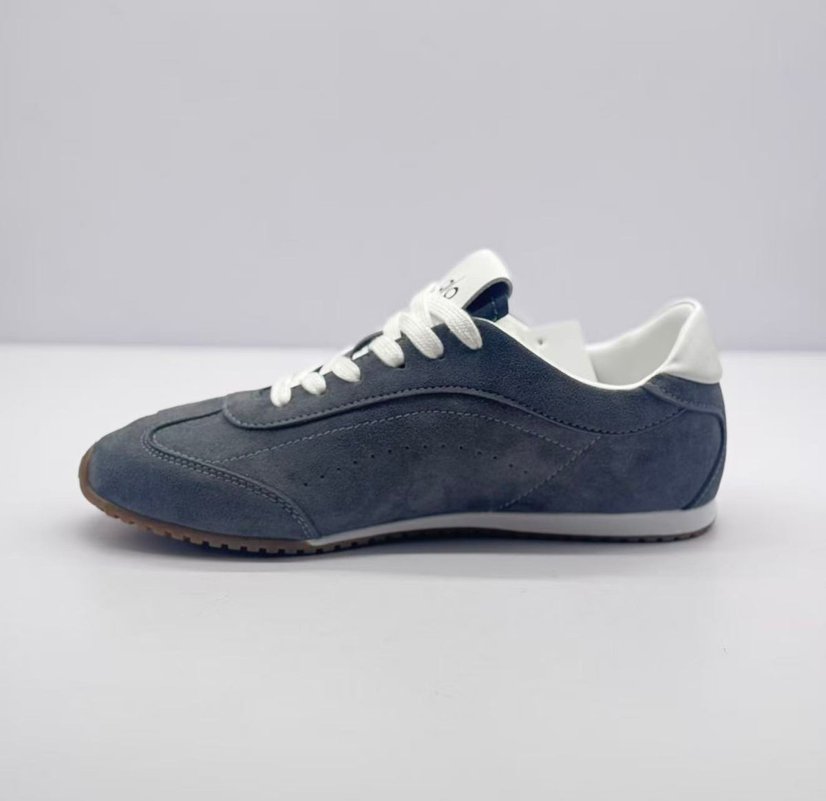 Opposite side profile showing the carbon gray upper, stitched panels, and white laces.