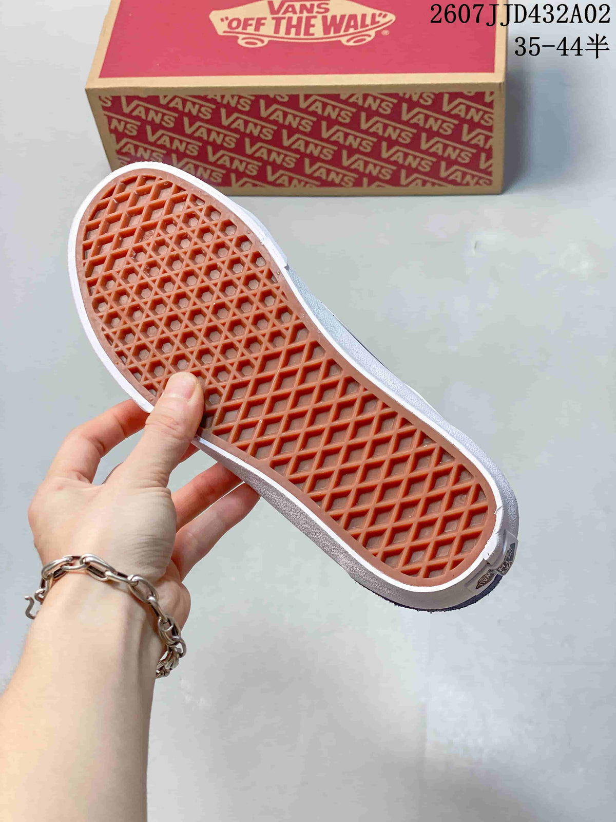 Underside of the sneaker showing patterned brown tread