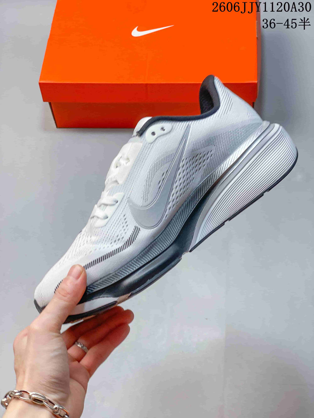 Side profile of a white and gray Nike Pegasus 42 running shoe
