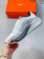 Side profile of a white and gray Nike Pegasus 42 running shoe
