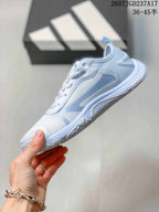 Side profile of the crystal blue sneaker showing its layered upper, low-profile sole and adidas side branding.