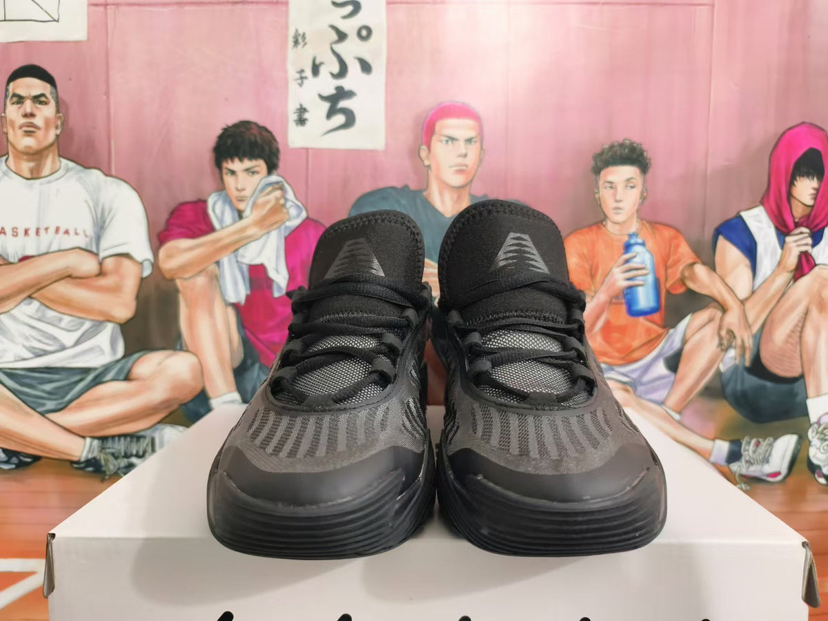Front view of all-black Nike basketball shoes with patterned uppers and lace-up closures
