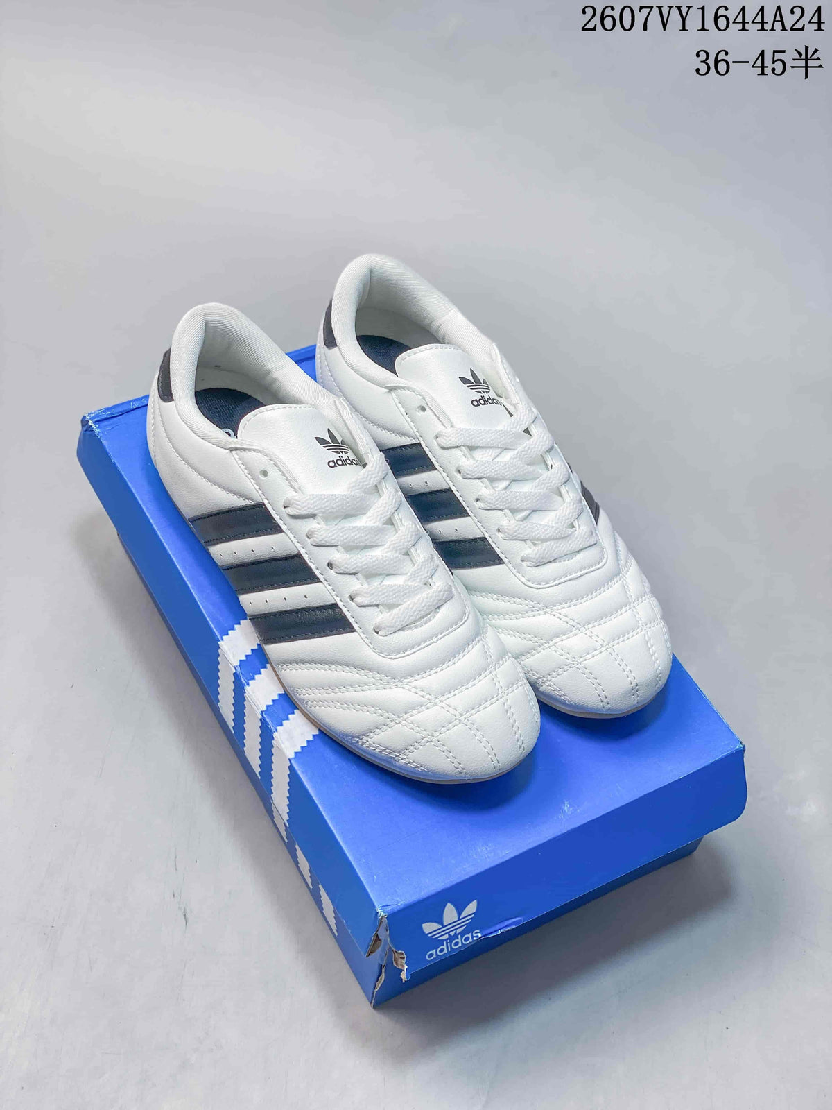 Pair of white adidas Taekwondo sneakers with dark navy stripes on a blue adidas shoebox; overlay shows style code 2607VY1644A24 and size range 36–45.