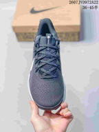 Front view showing the rounded toe, mesh-style upper, tongue, and lacing system.