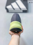 Rear view of an Adidas Supernova Rise sneaker showing the dark gray heel, lime-green heel section, and black outsole; image text shows size range 40–45.