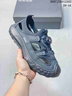 Side view of a dark gray ECCO closed-toe sandal showing open side panels and a chunky textured sole.
