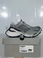 Pair of gray, silver and black sneakers displayed on a shoebox; the box label shows size E 40 and the color text “GREY/SILVER/BLK/W”.