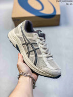 Angled side view of the gray ASICS Gel-Contend 4 sneaker showing the layered mesh panels, contrasting side branding, midsole, and outsole.