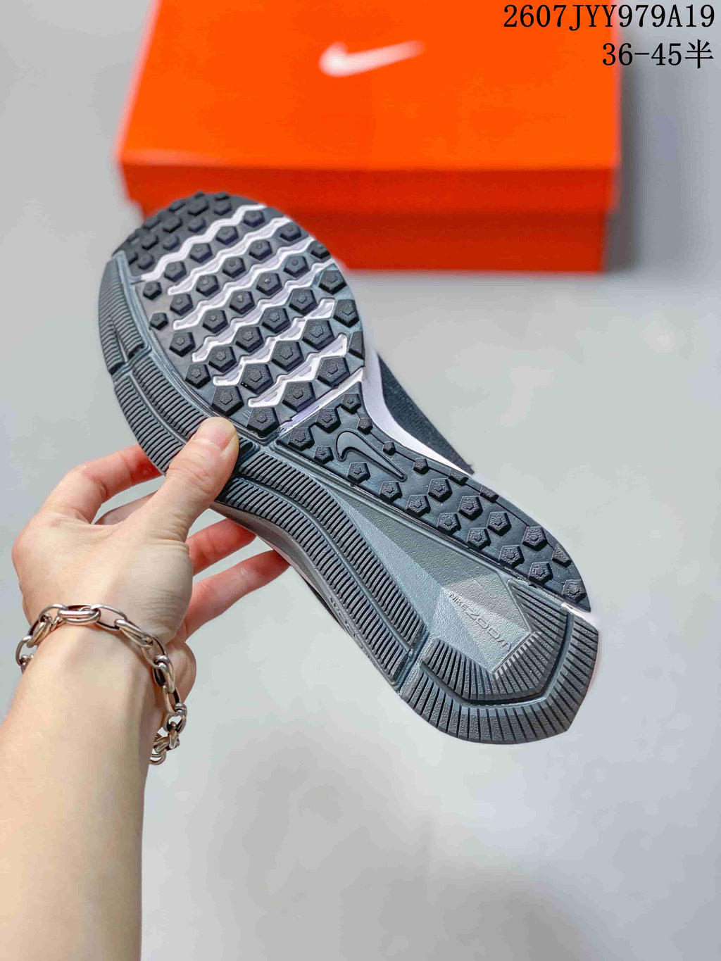 Bottom view showing the textured black and white outsole of a Nike running sneaker.