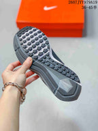 Bottom view showing the textured black and white outsole of a Nike running sneaker.
