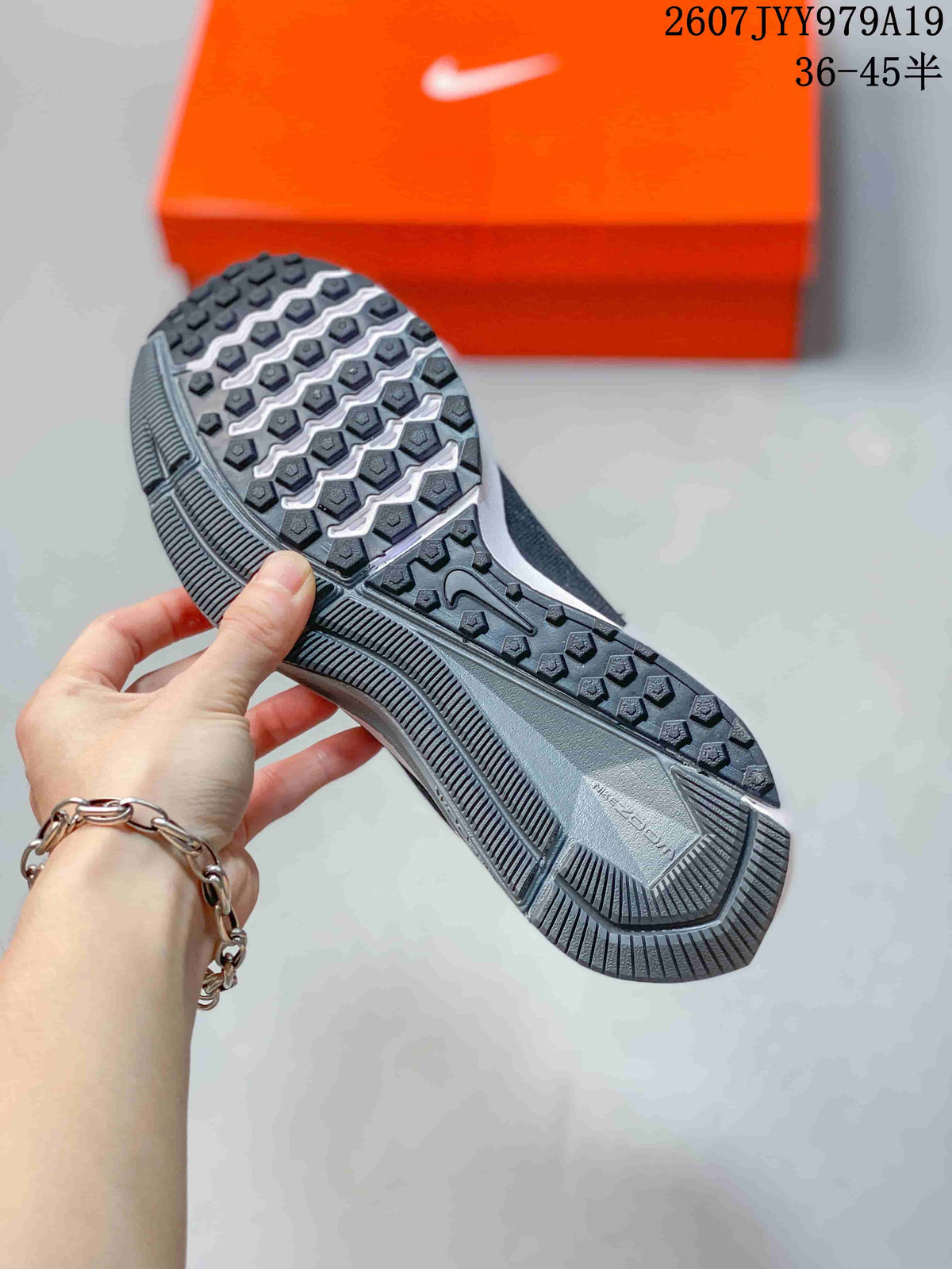 Bottom view showing the textured black and white outsole of a Nike running sneaker.