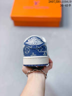 Rear view of the sneaker showing the blue patterned heel panel, white midsole, and blue outsole edge.