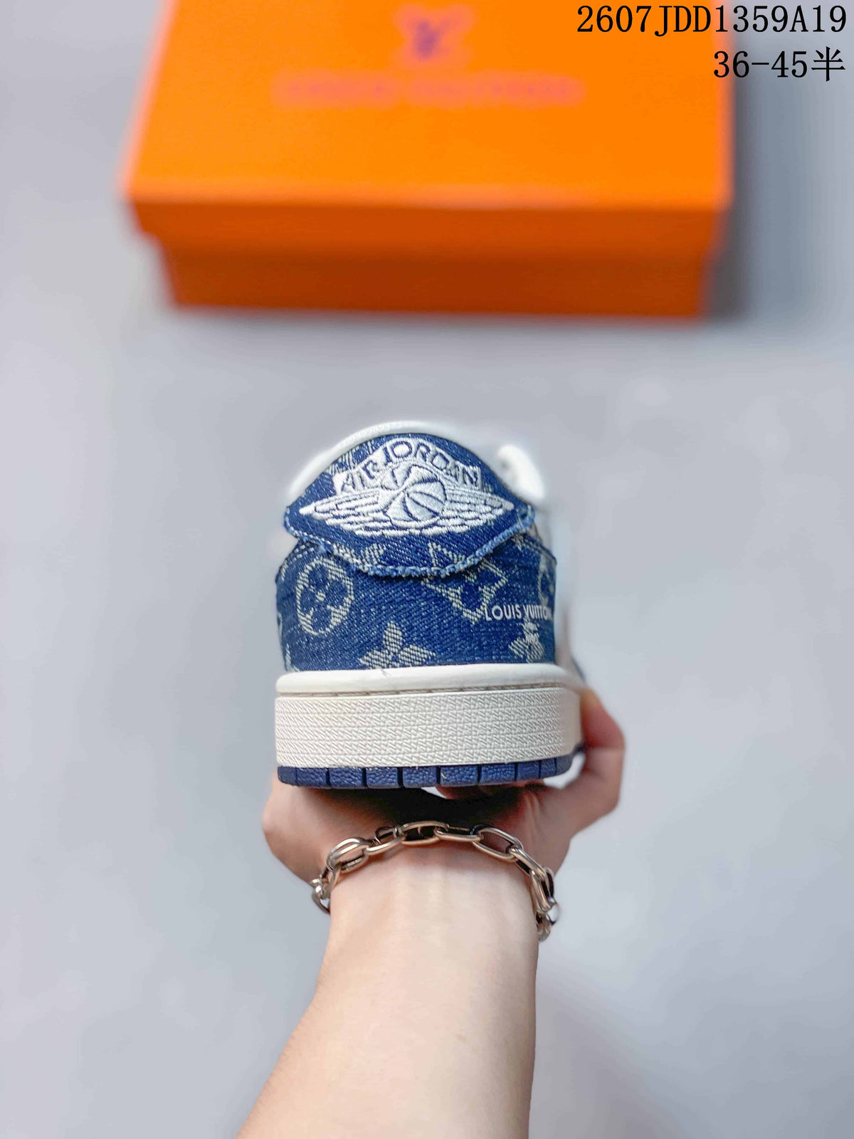 Rear view of the sneaker showing the blue patterned heel panel, white midsole, and blue outsole edge.