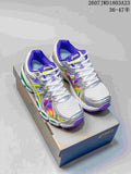 Pair of ASICS Gel-Nimbus 16 sneakers displayed on an ASICS shoebox, showing white, silver, purple, lime, and multicolor detailing.