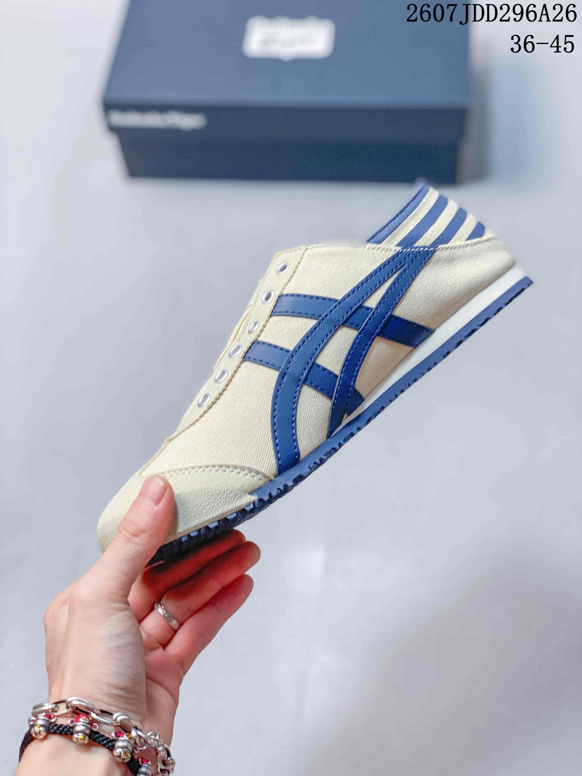 Side profile of a cream and navy Onitsuka Tiger Mexico 66 slip-on sneaker, showing the side stripes and low-profile sole; image text shows size range 36-45.