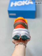 Rear view of the coral trail running shoe showing the padded orange collar, heel structure, white midsole, and teal outsole lugs.