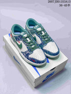 Pair of blue, white and green Nike-marked low-top sneakers displayed on a shoebox, with style code JDD1353A13 and size range 36–45 visible.