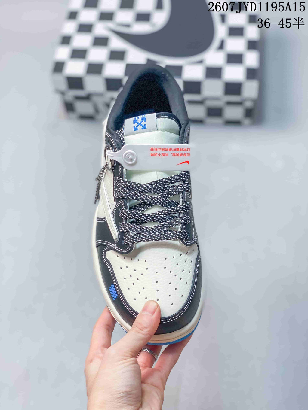 Top view showing the perforated white toe box, black overlays, patterned laces, and tongue details.