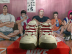 Front view of cream Nike sneakers with red laces and cherry-themed details