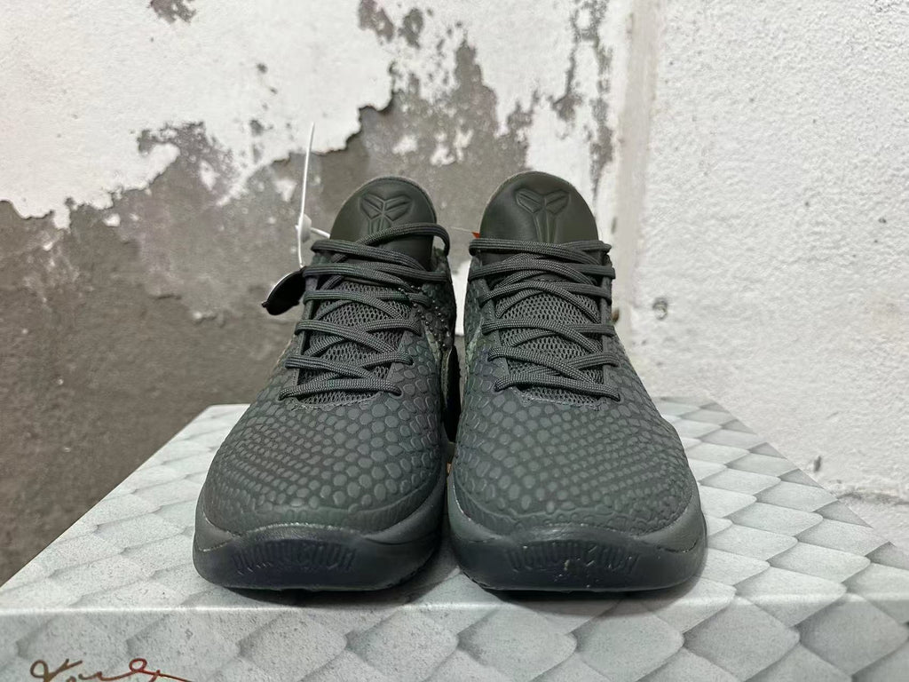 Front view of the dark Nike Kobe 6 shoes with textured uppers and lace-up closure