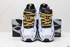 Front view of the pair showing the white mesh toes, yellow laces, black tongues, and blue detailing.