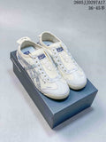 Pair of off-white and pale blue Onitsuka Tiger Mexico 66 Deluxe sneakers displayed on a branded shoebox; JJD297A17 and the size range 36–45.5 are visible.