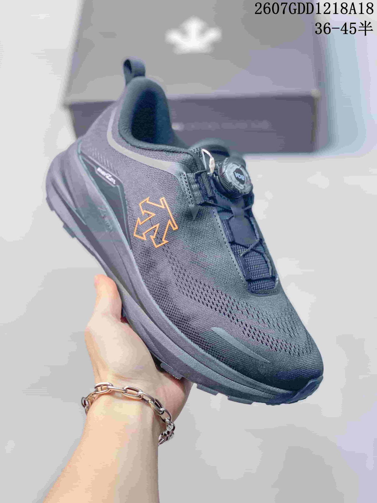 Angled side view showing the DESCENTE logo, dark gray upper, BOA dial, and chunky lugged outsole.