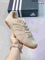 Cream adidas Ghost Sprint sneaker shown close up with an adidas shoe box in the background.