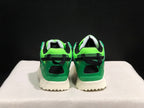 Rear view showing the green heel panels, black heel accents, and textured cream outsole.