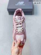 Top view showing the lace-up construction, padded tongue, mesh-look toe panel, and pink-and-white color blocking.
