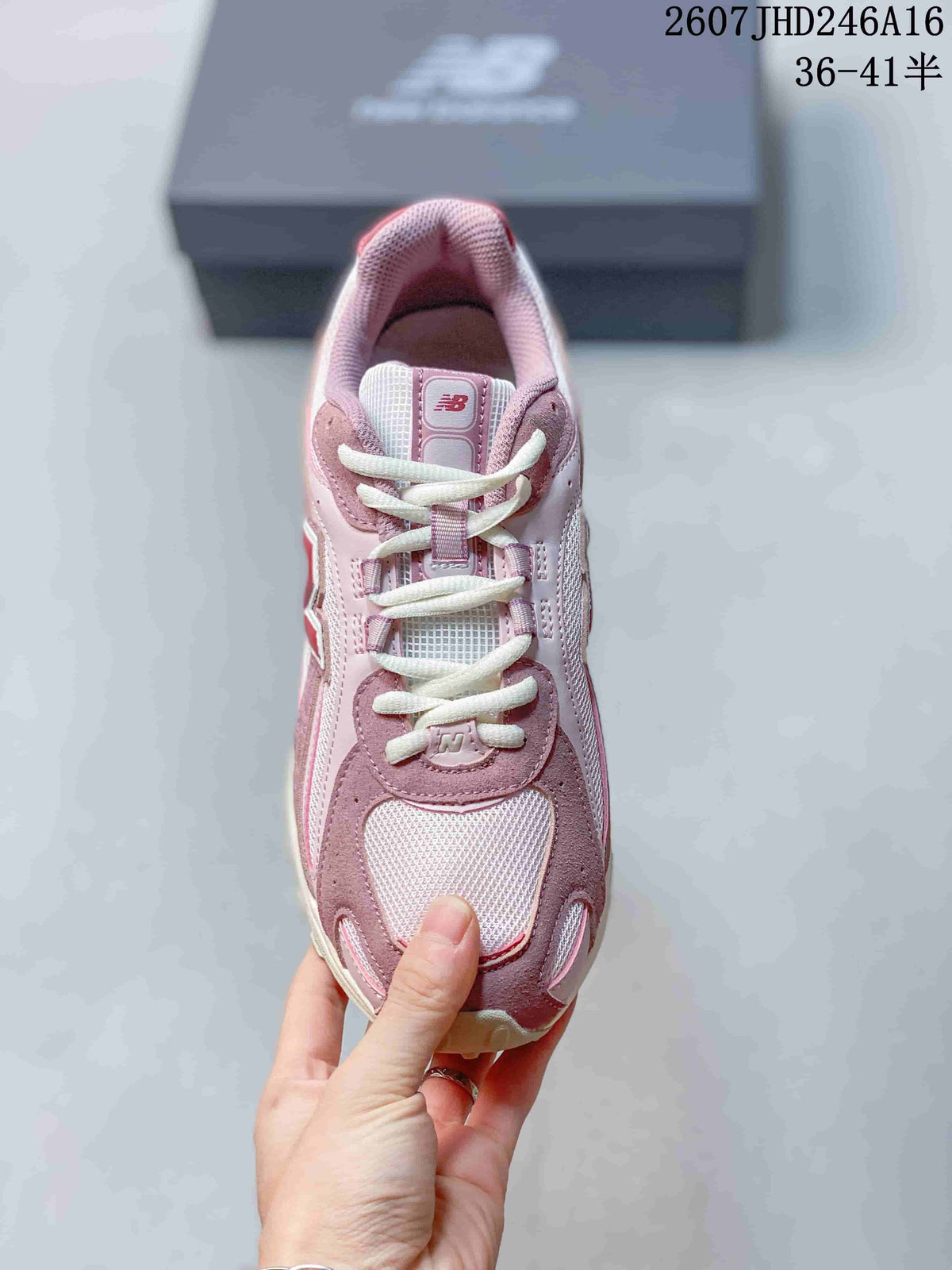 Top view showing the lace-up construction, padded tongue, mesh-look toe panel, and pink-and-white color blocking.