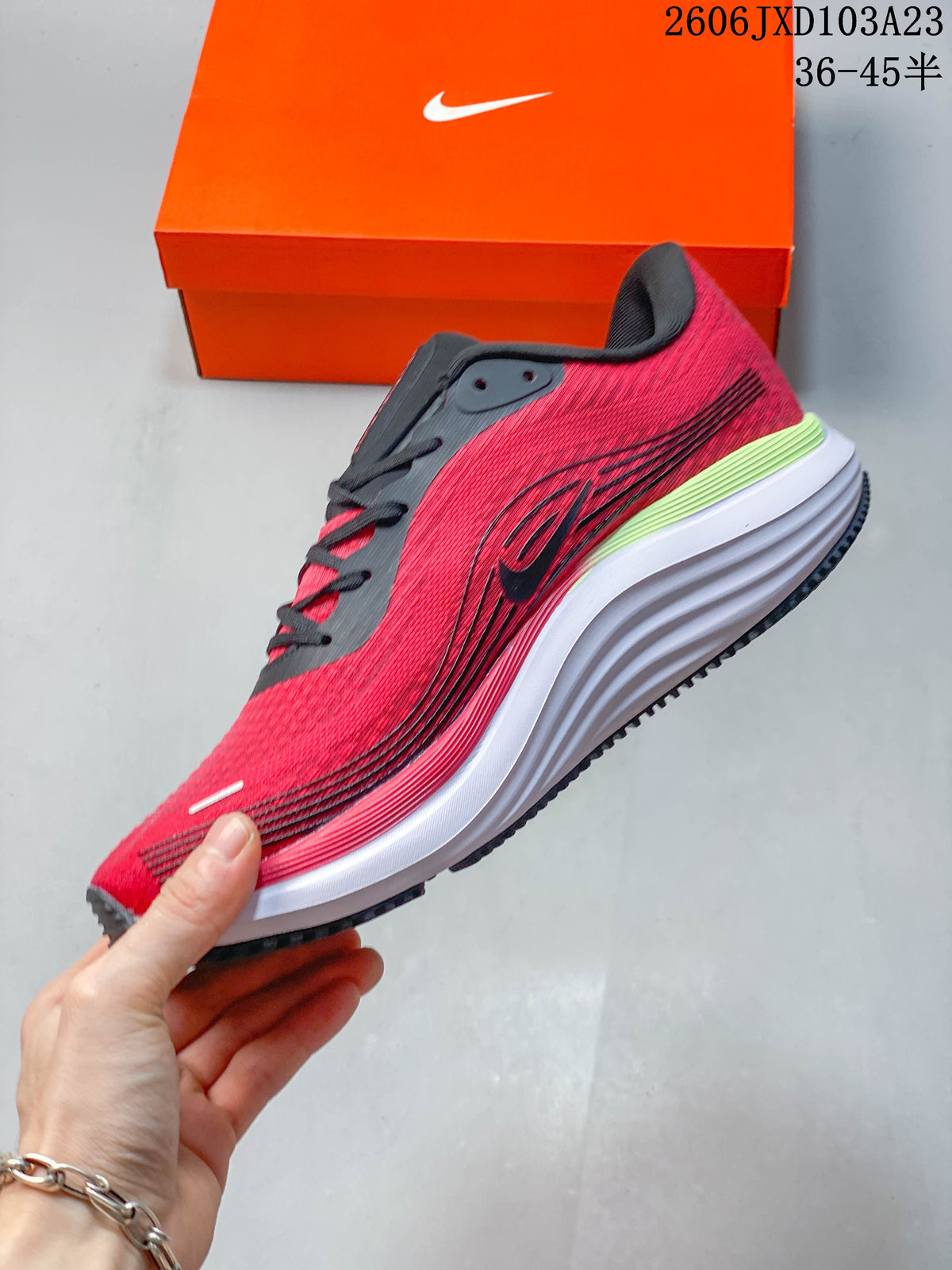 Side view of a red and black running shoe with a white midsole and lime heel accent