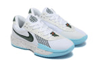 Angled view of the pair showing white uppers, green details, light blue soles, and speckled midsoles.