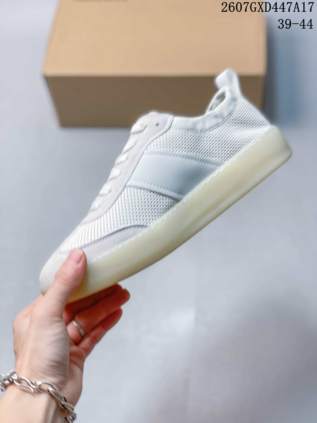 Side profile highlighting the perforated upper, tonal side panel and low-top silhouette.