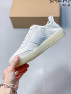 Side profile highlighting the perforated upper, tonal side panel and low-top silhouette.